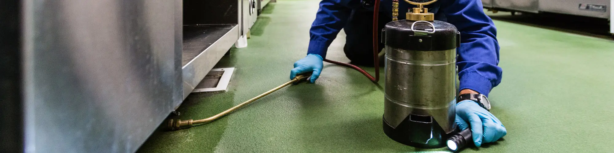 EntoLogic technician performing documented commercial pest control service